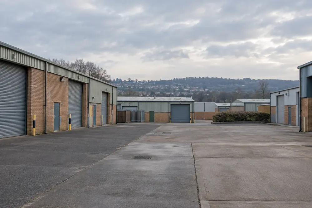 Brick commercial units with roller shutters on a Bristol-area industrial estate